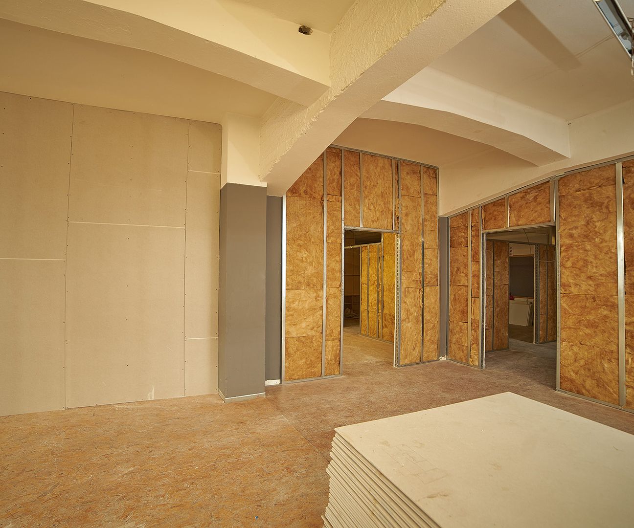 Ein Raum mit vielen Holzpaneelen und viel leerem Platz, der eine ruhige und offene Atmosphäre vermittelt.